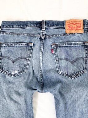 Vintage Levi's distressed 505 blue jeans with a straight leg fit